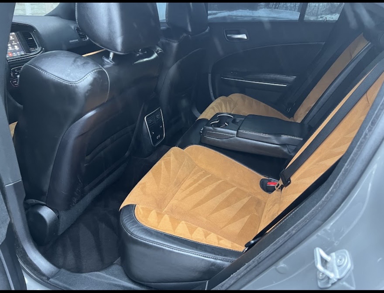 Detailed vehicle interior with two-tone leather and suede rear seats